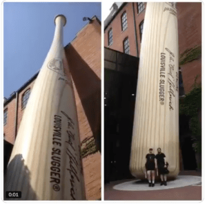 Collage of one shot of the towering huge baseball bat that is taller than the museum building itself and then one of two very small looking people standing at the bottom of it